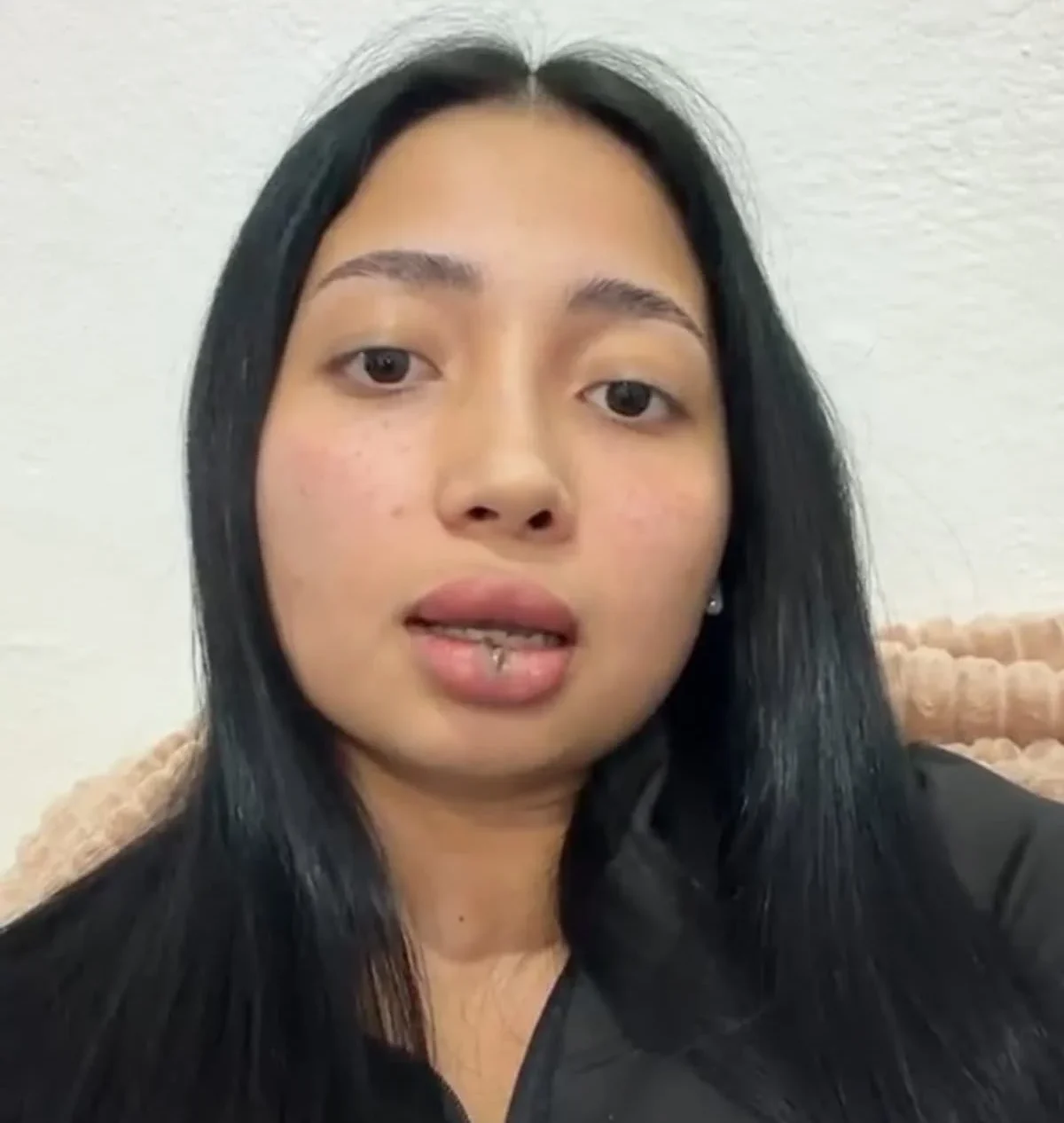 A woman speaking in a video, accusing a former Tulum official of domestic violence and attempted femicide