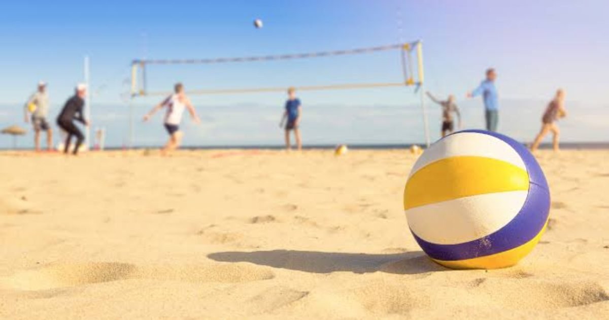Young athletes playing beach volleyball on a sandy court in Isla Mujeres, Quintana Roo