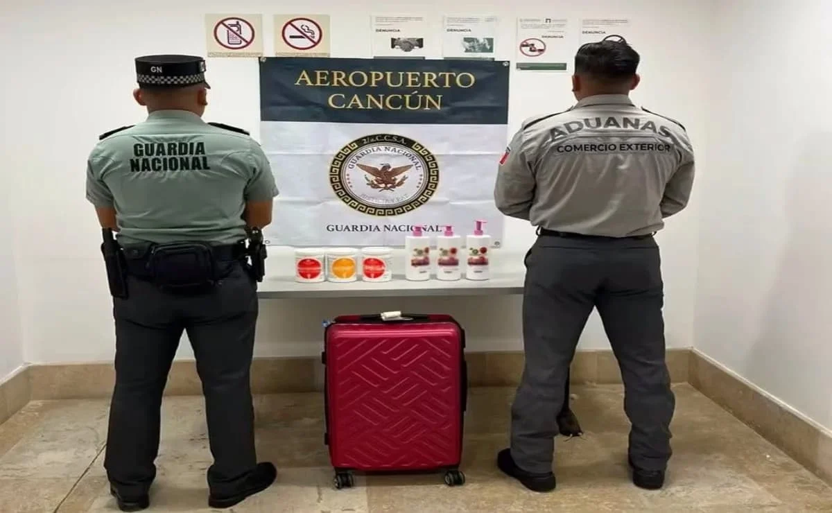 Authorities inspect an abandoned suitcase containing ketamine found in the customs area of Cancun International Airport.