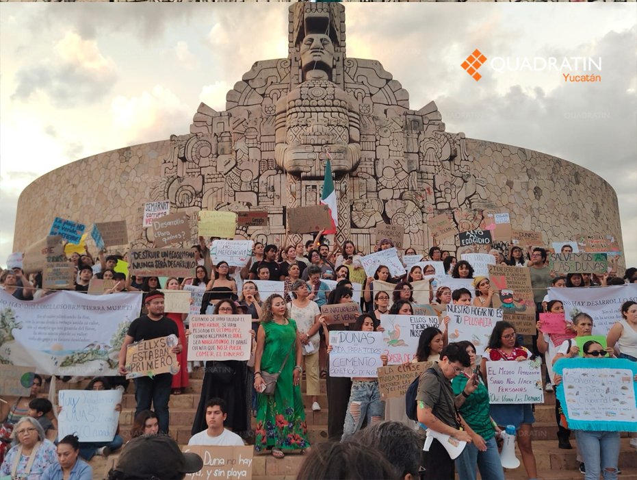Environmental activists hold signs during a protest against the Las Dunas real estate development in Mérida, Yucatán.