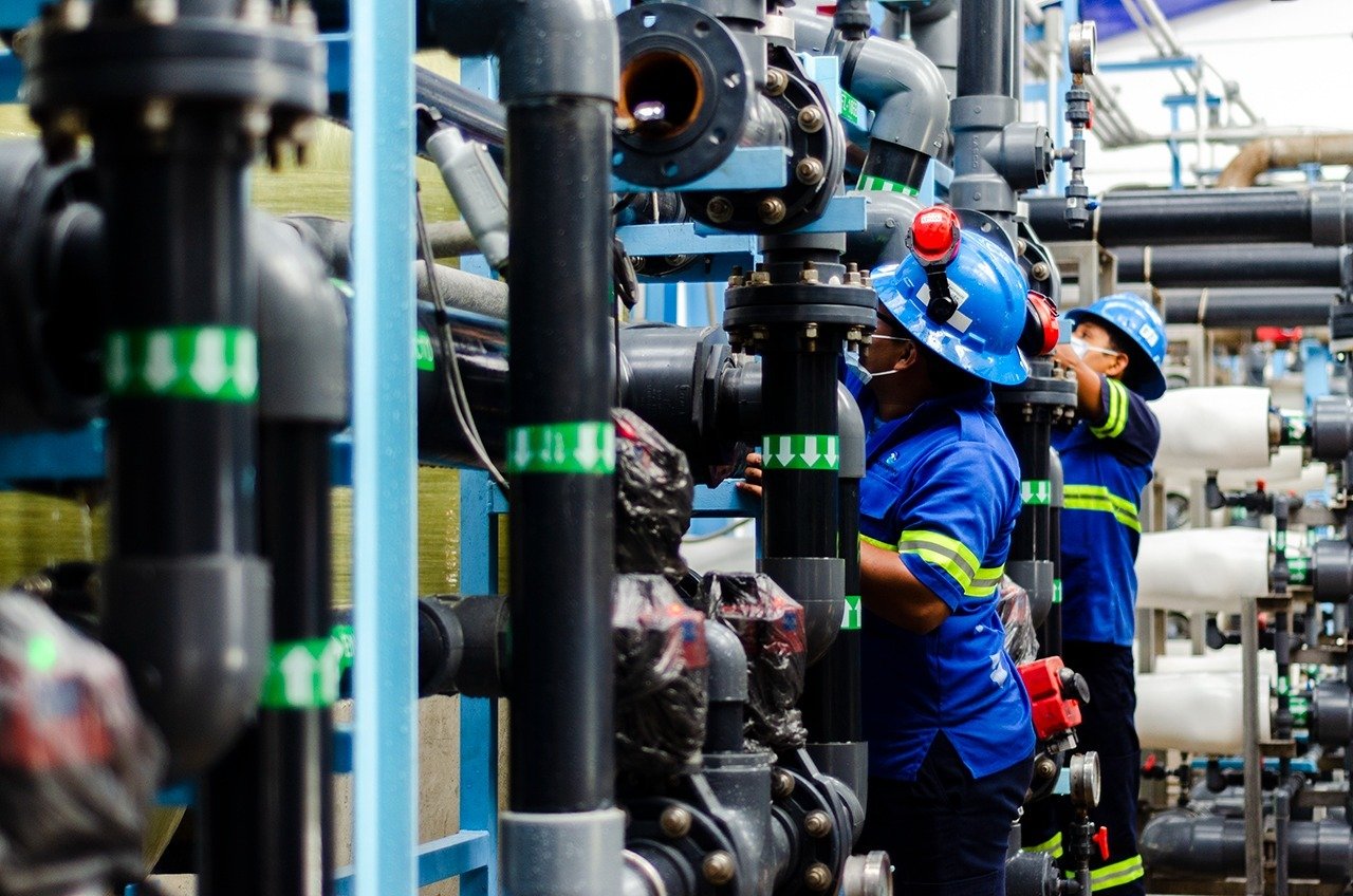 Workers performing maintenance at the Aguakan desalination plant in Puerto Aventuras
