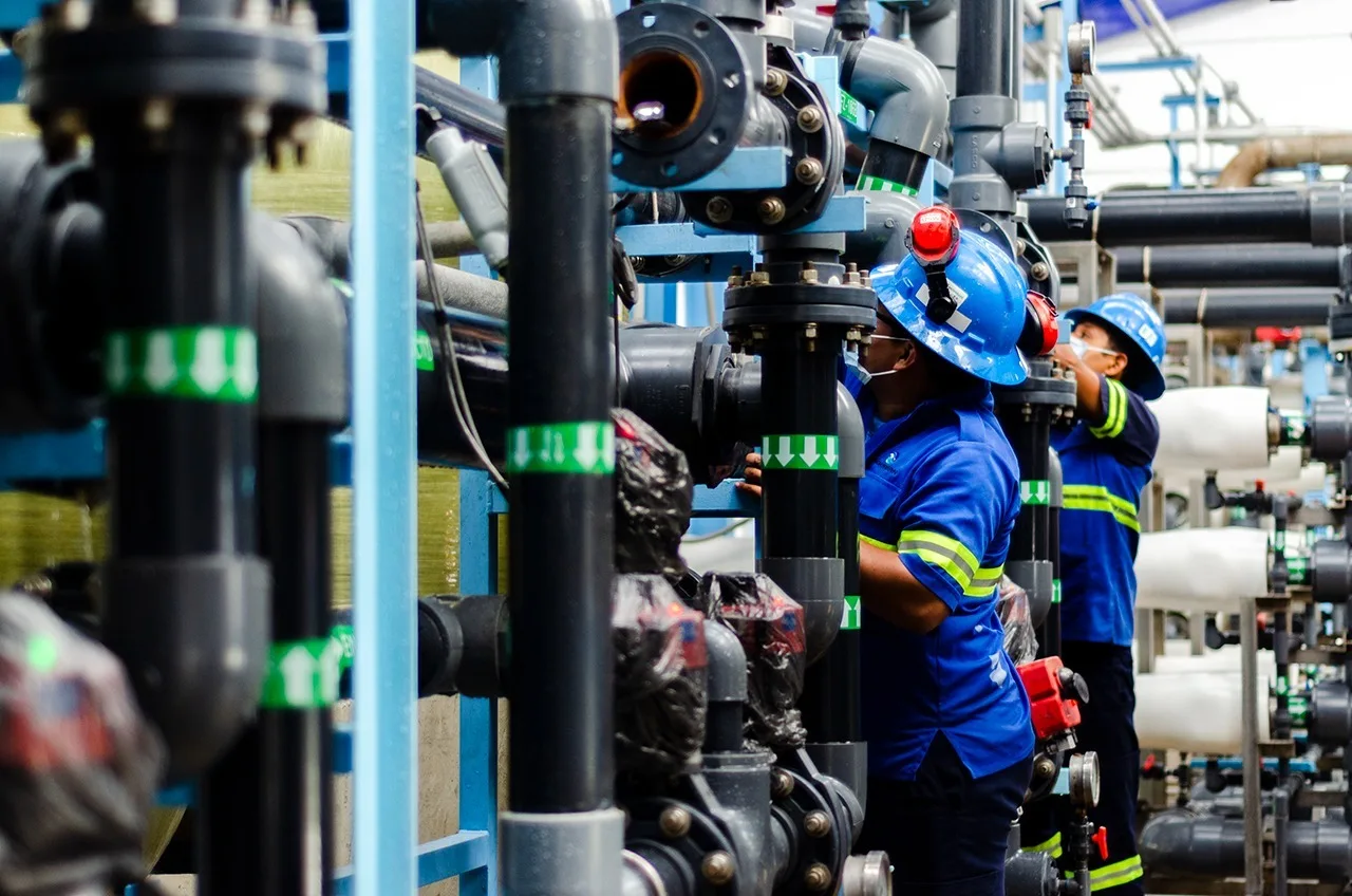 Workers performing maintenance at the Aguakan desalination plant in Puerto Aventuras