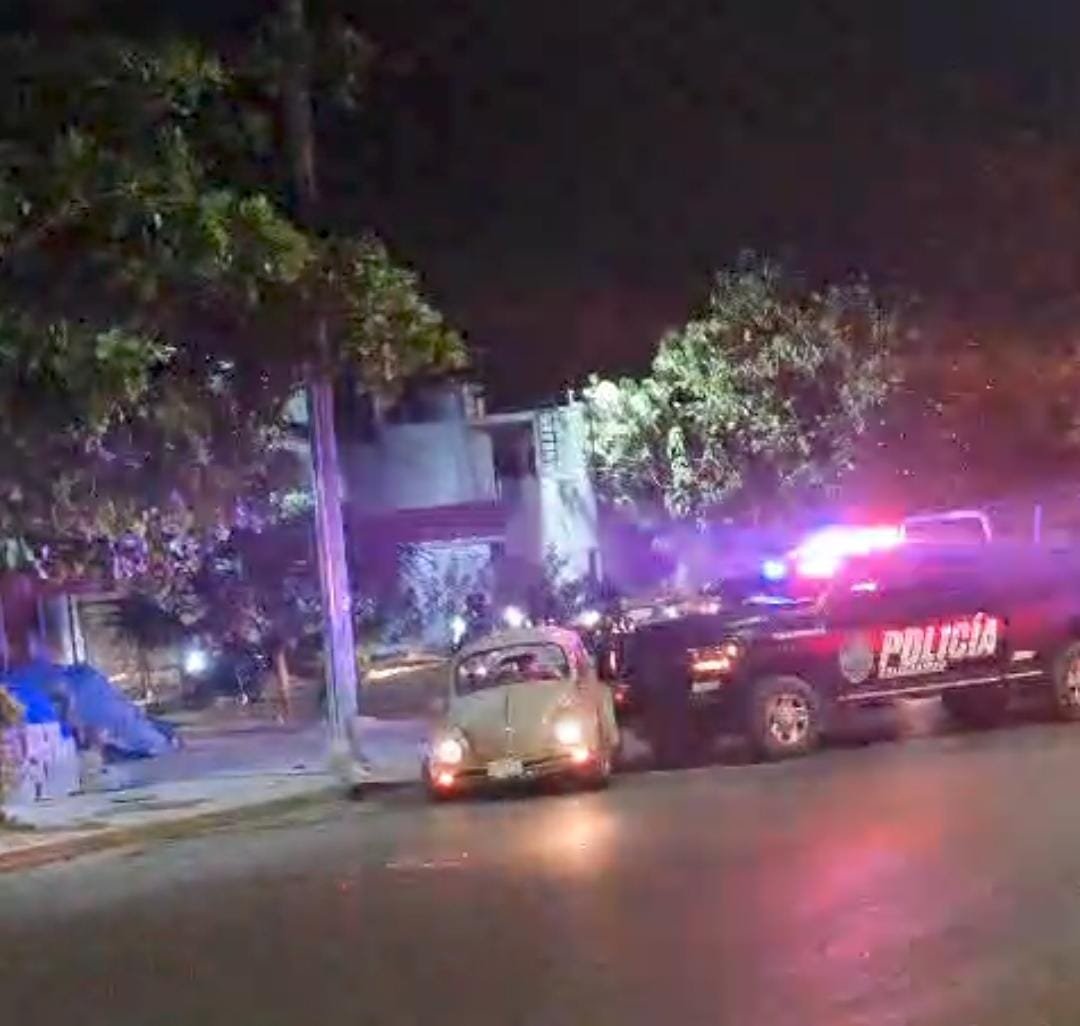 A police patrol car blocks a Volkswagen Beetle on a sidewalk in Playa del Carmen during a chase involving an allegedly drunk female driver.