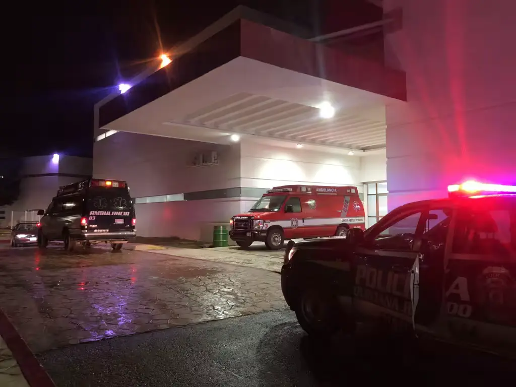 Police officers inspect damage after an armed attack on a bar in Puerto Aventuras, Quintana Roo.
