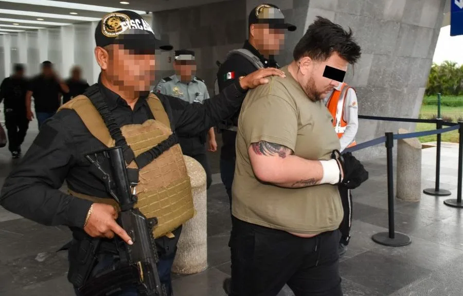 Mexican police escort a handcuffed man believed to be El Ruso during his arrest in Zapopan