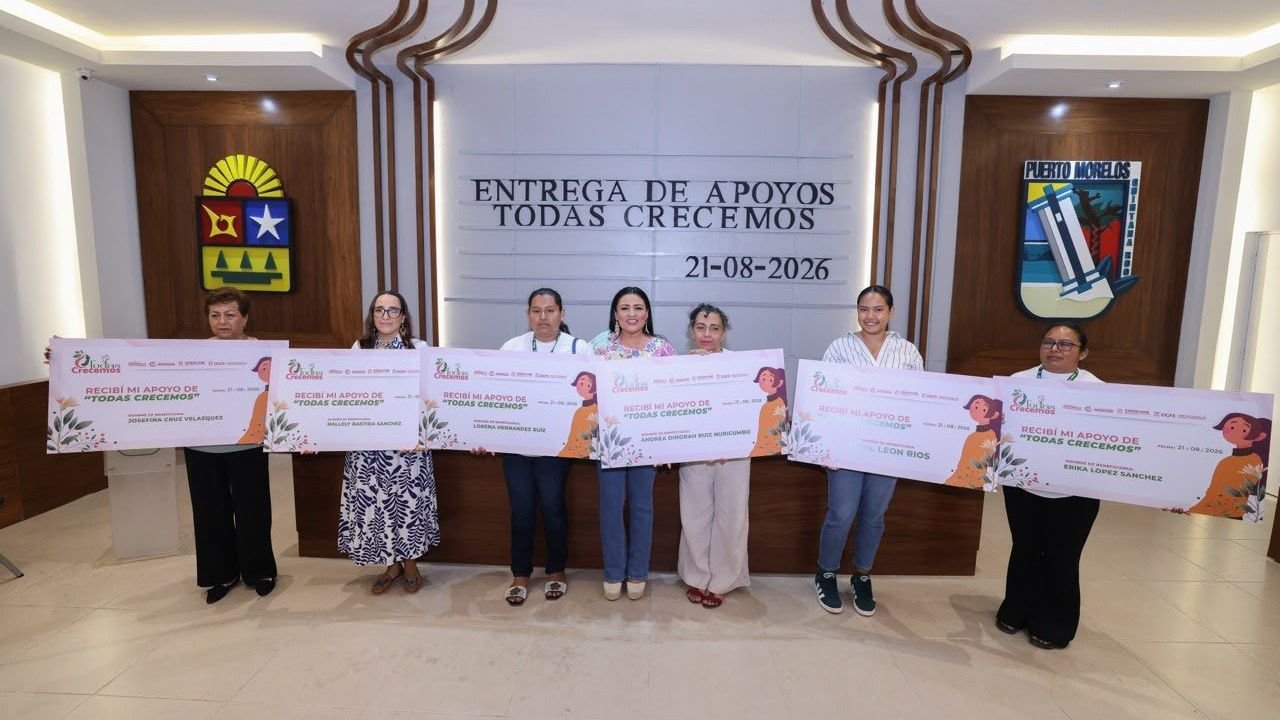 Mayor Blanca Merari Tziu Muñoz delivers a symbolic check to a woman entrepreneur at the Todas Crecemos program ceremony in Puerto Morelos.