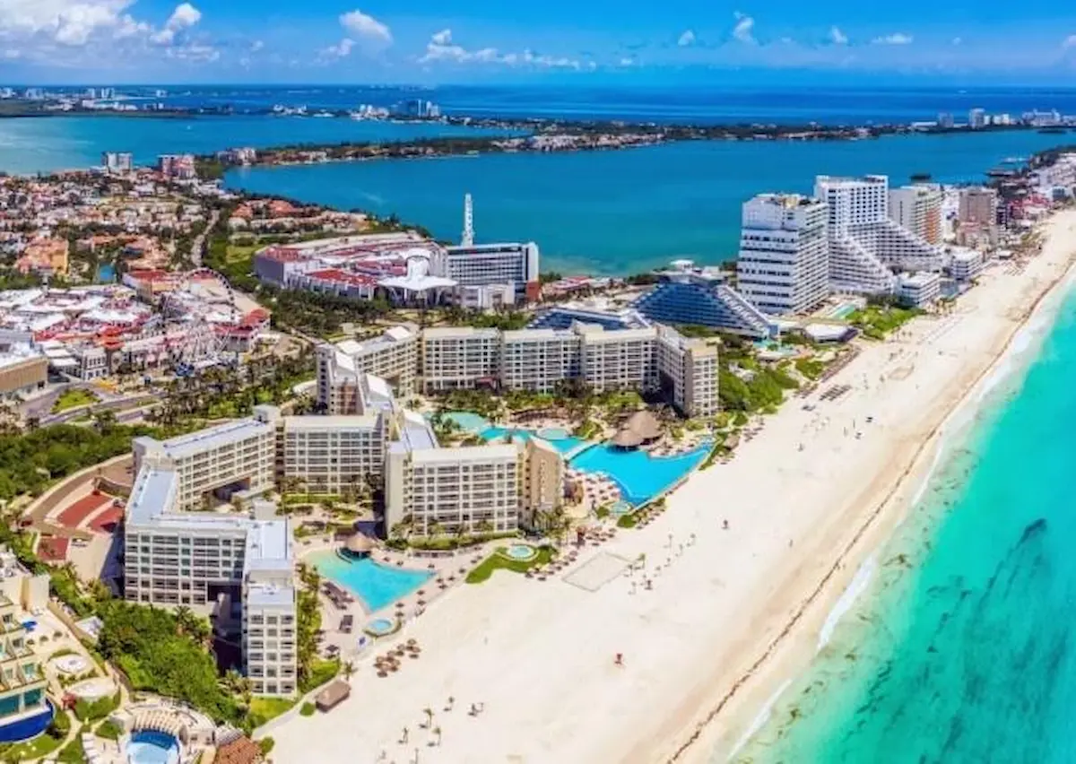 Tourists relax by the pool at an all-inclusive resort in the Cancun hotel zone