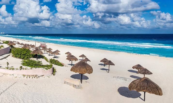 A couple on a beach in Cancún, where officials warned that public intimate acts are punishable by fines and administrative arrest.