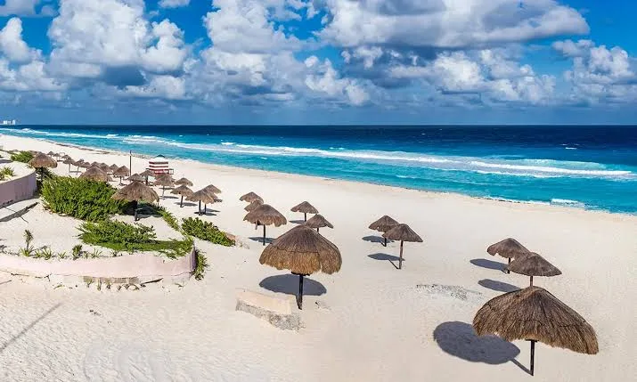 A couple on a beach in Cancún, where officials warned that public intimate acts are punishable by fines and administrative arrest.