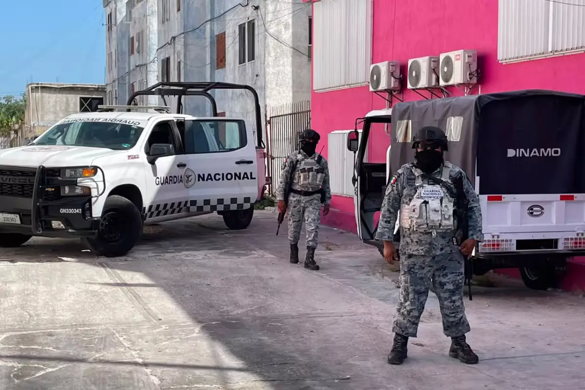 Authorities outside a home in Cancún during a search warrant operation in a child trafficking investigation.