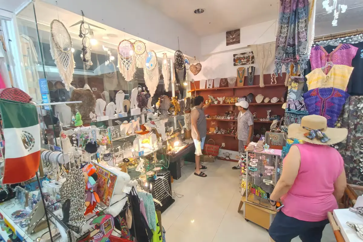 Artisan vendors wait for customers in an empty Cancun shopping plaza during the summer tourist season.
