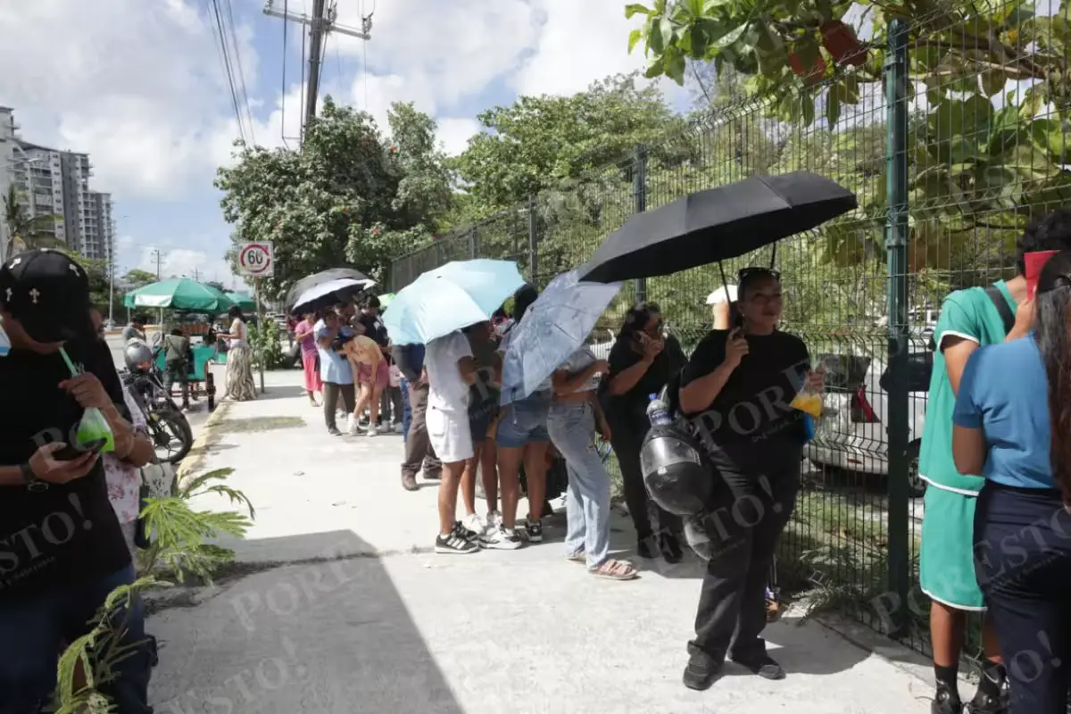 Parents and students gather outside a school in Cancún, Mexico, during the high school placement process.
