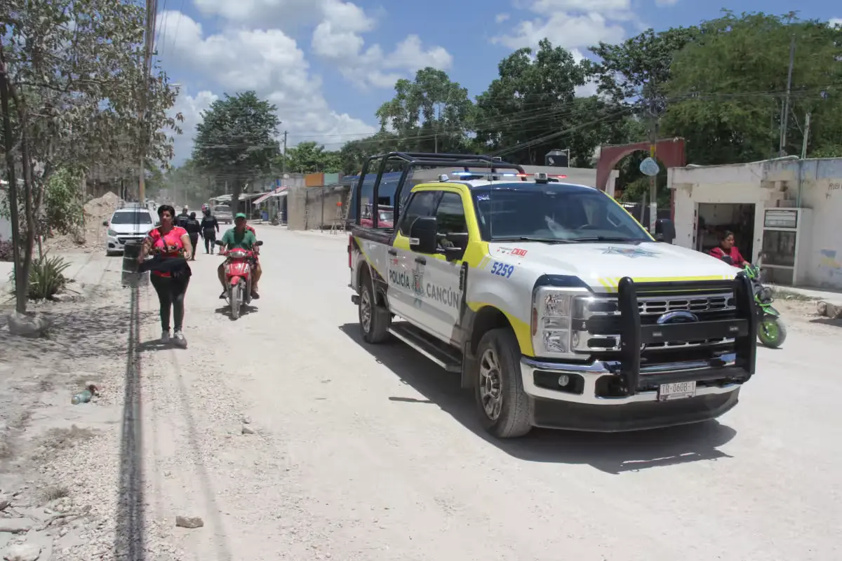 Police officers talk with residents during a community patrol in an informal neighborhood in Cancun.