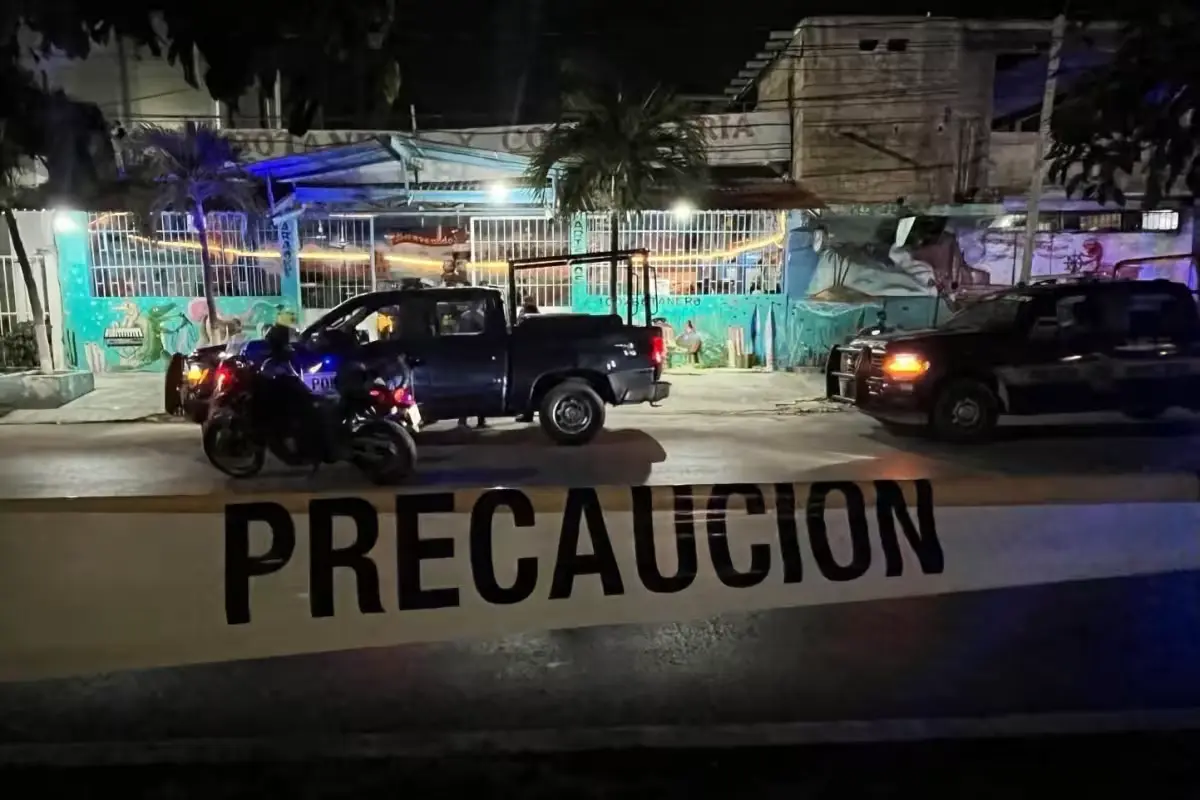 Police officers at the scene of the fatal shooting at the El Paisa cocktail bar in Cancun