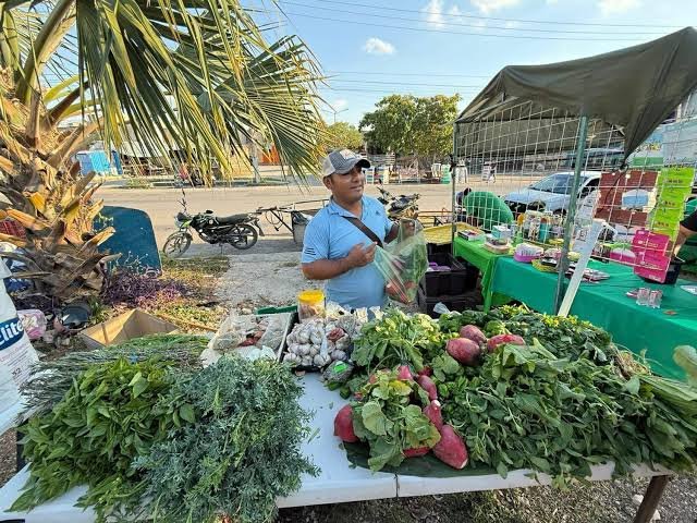 Vendors at an outdoor street market in Cancun wait for customers during a hot summer day