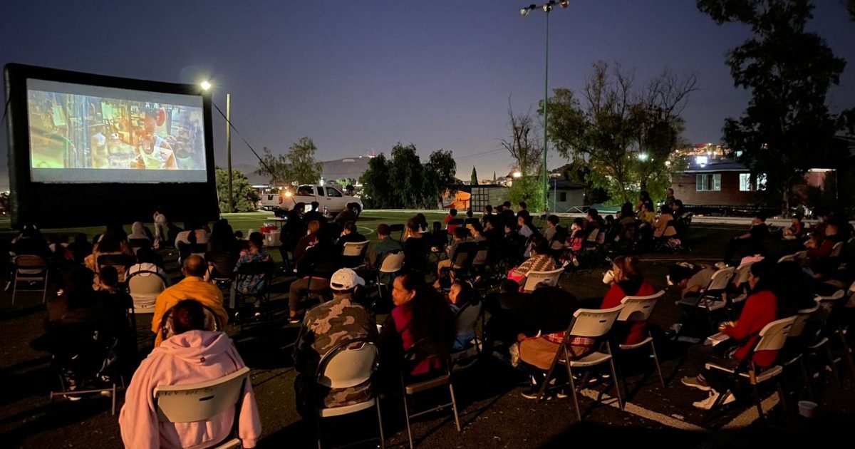 An outdoor movie screen set up for a free community screening in Playa del Carmen