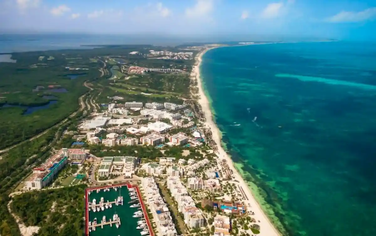 Construction equipment and workers on the Costa Mujeres highway expansion project in Quintana Roo, Mexico.
