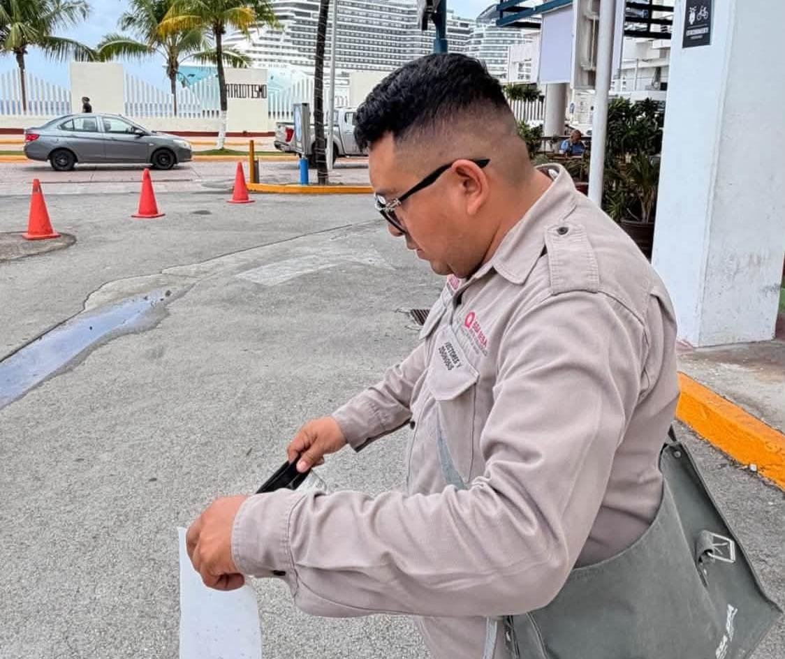 A vector control worker checks a mosquito trap at Punta Langosta cruise terminal in Cozumel, Quintana Roo