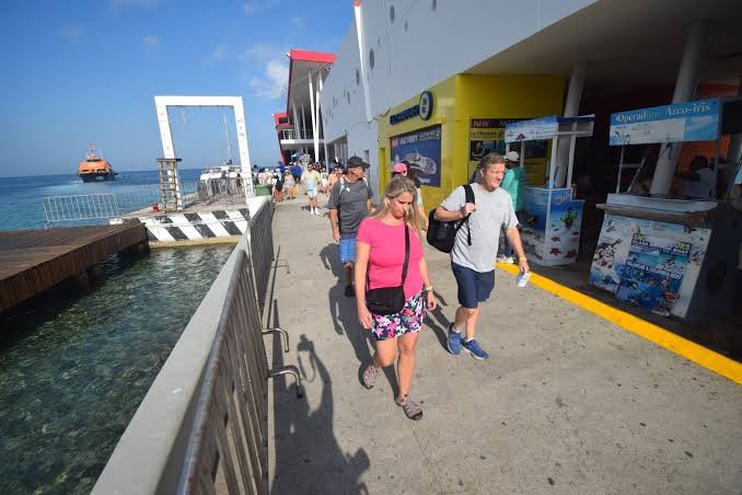 Tourism promoters on Cozumel wait for customers during a slow summer season