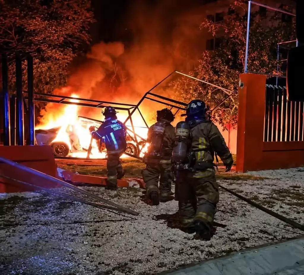 The damaged access gate and perimeter wall of Colegio Libertad after the crash.