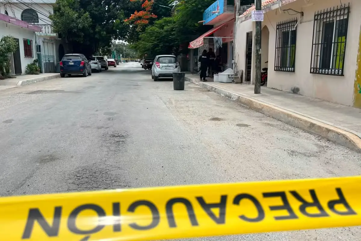 Police officers secure the area in downtown Tulum where a gunman dropped a magazine during a failed attack.