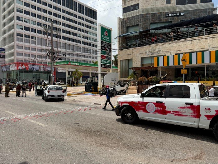 Emergency personnel at the scene of a fatal crash on Bonampak Avenue in Cancun