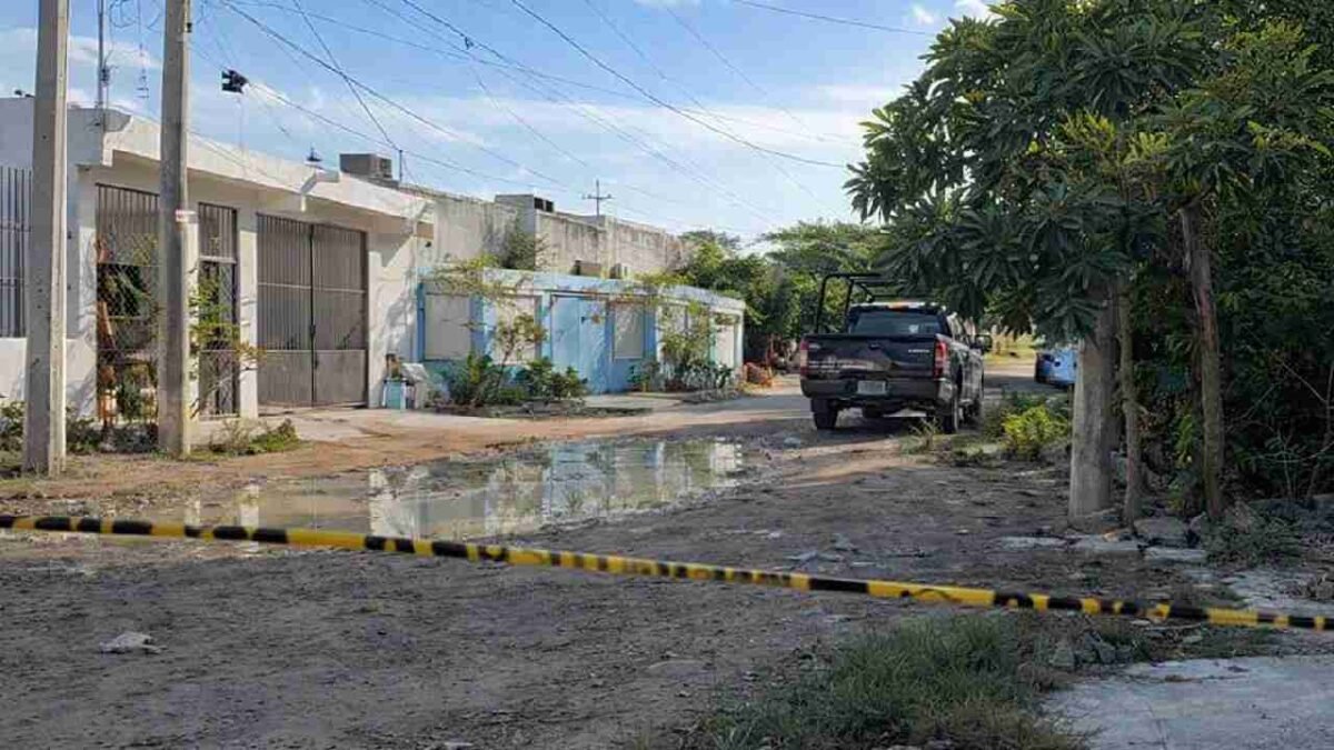 Police officers cordon off a home in Cancún where a girl was found dead with signs of violence