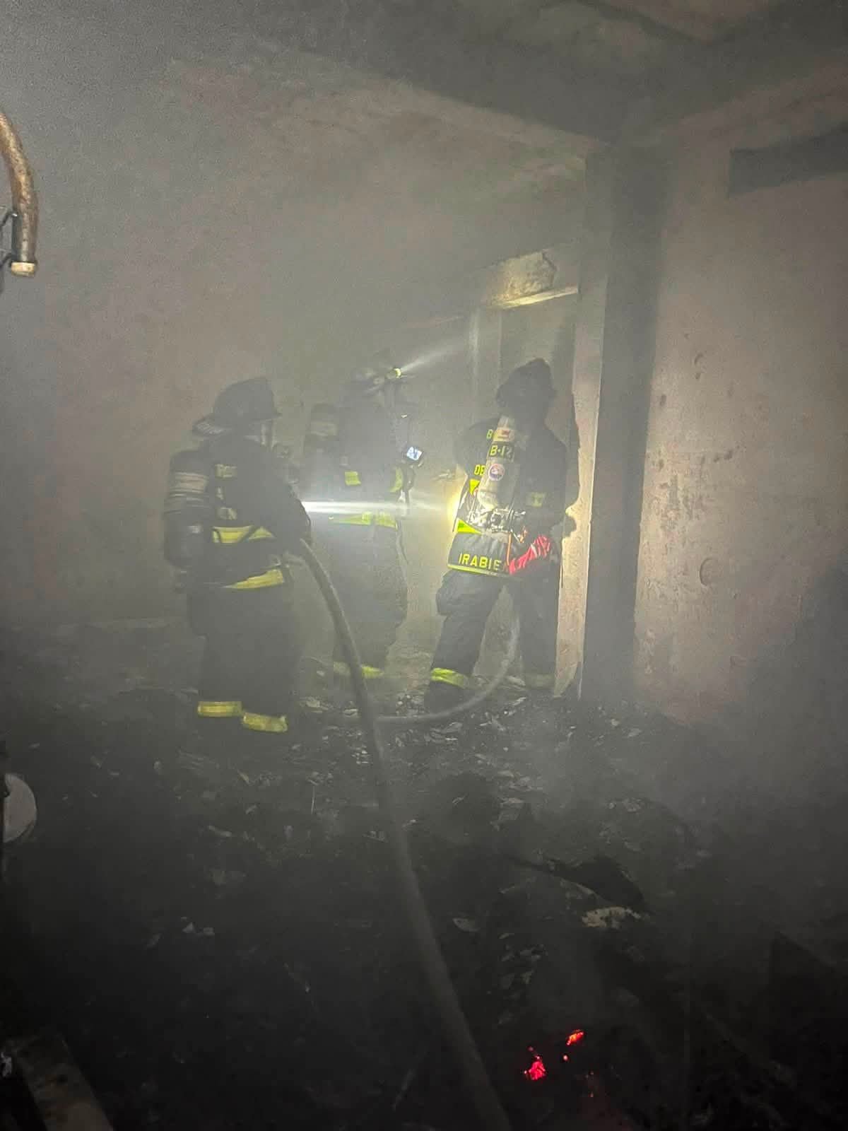 Firefighters extinguish a fire at a home in the In House neighborhood of Playa del Carmen