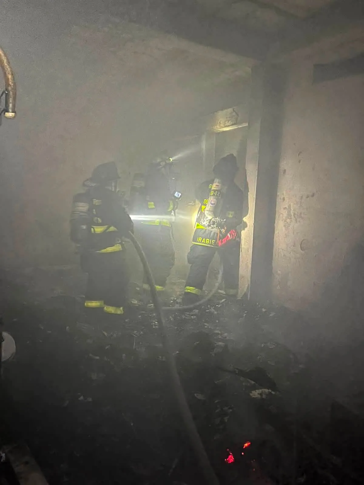 Firefighters extinguish a fire at a home in the In House neighborhood of Playa del Carmen
