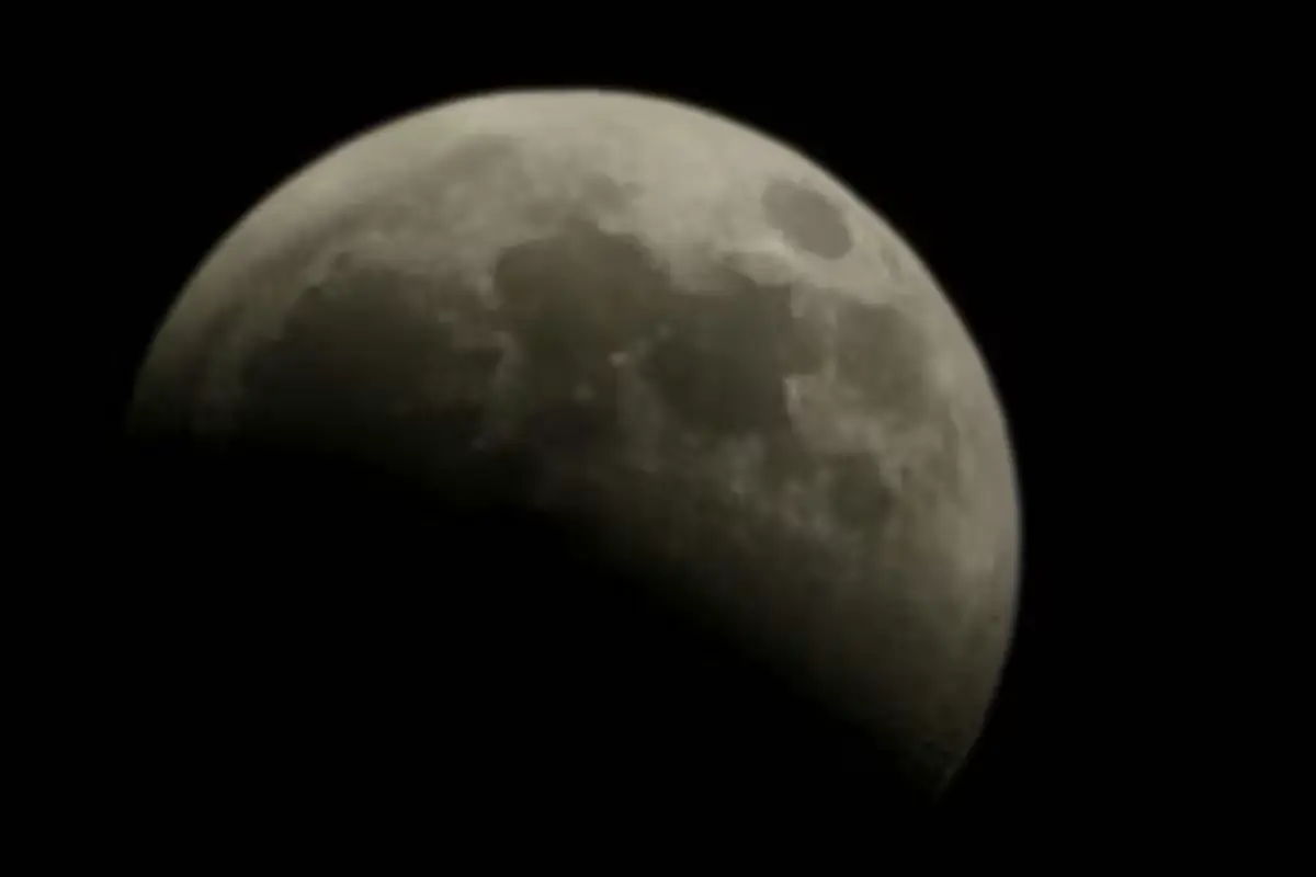 Residents gathered outdoors in Cancun watch the lunar eclipse on August 27, 2026.