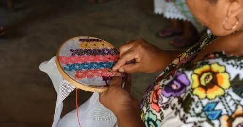 Traditional Maya embroidery from the Yucatan Peninsula with colorful floral designs