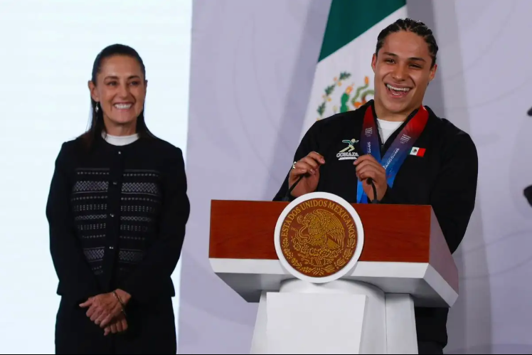Mexican athletes stand with President Claudia Sheinbaum during her morning press conference in Mexico City