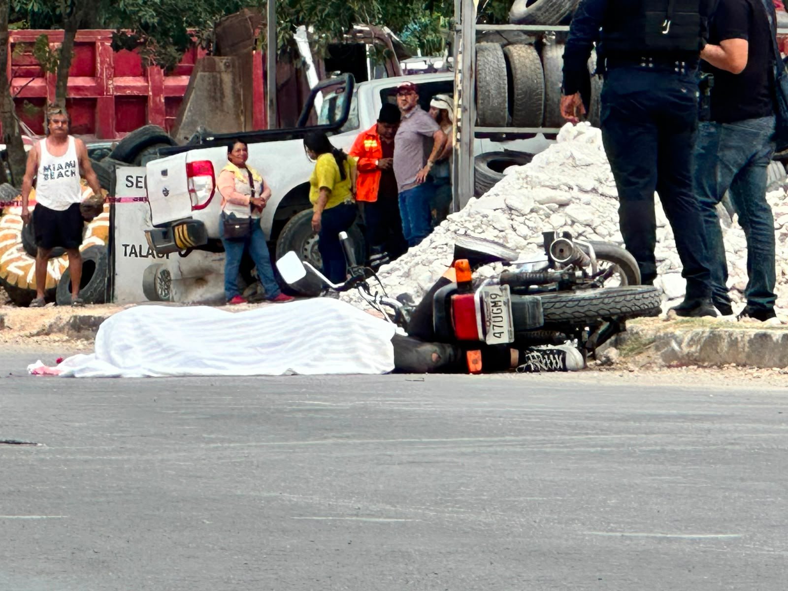 Traffic agents cordoned off the scene after a woman on a motorcycle was run over by a Coca-Cola truck in Playa del Carmen