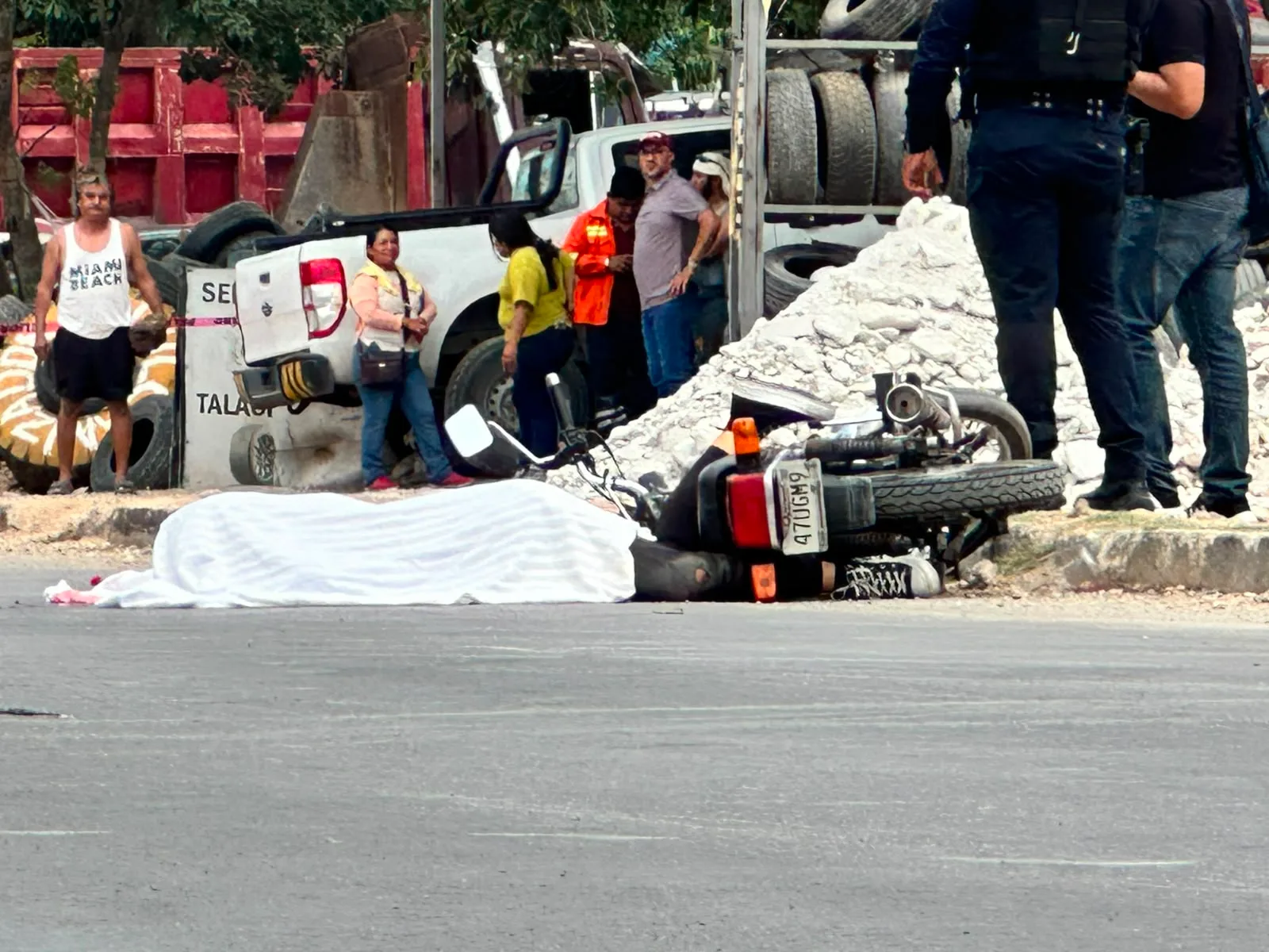 Traffic agents cordoned off the scene after a woman on a motorcycle was run over by a Coca-Cola truck in Playa del Carmen