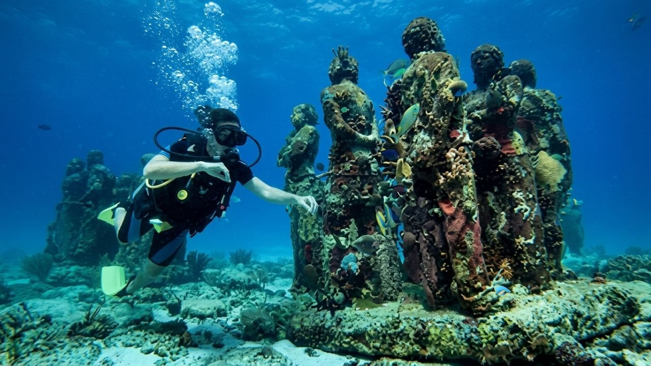 Tourists snorkeling above the underwater sculptures at MUSA Cancun