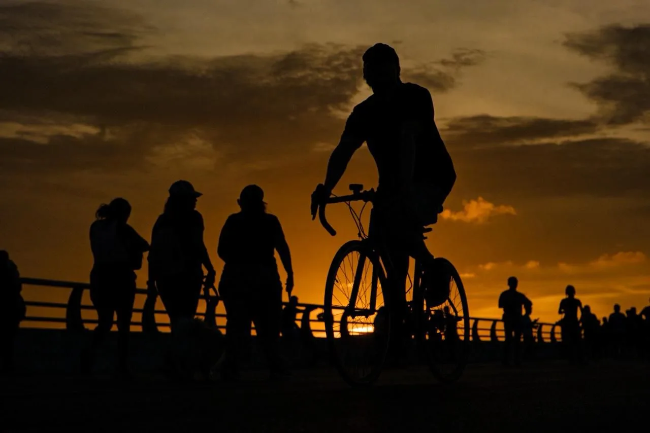 People cycle and walk along the Nichupté Bridge during a family event in Cancún.
