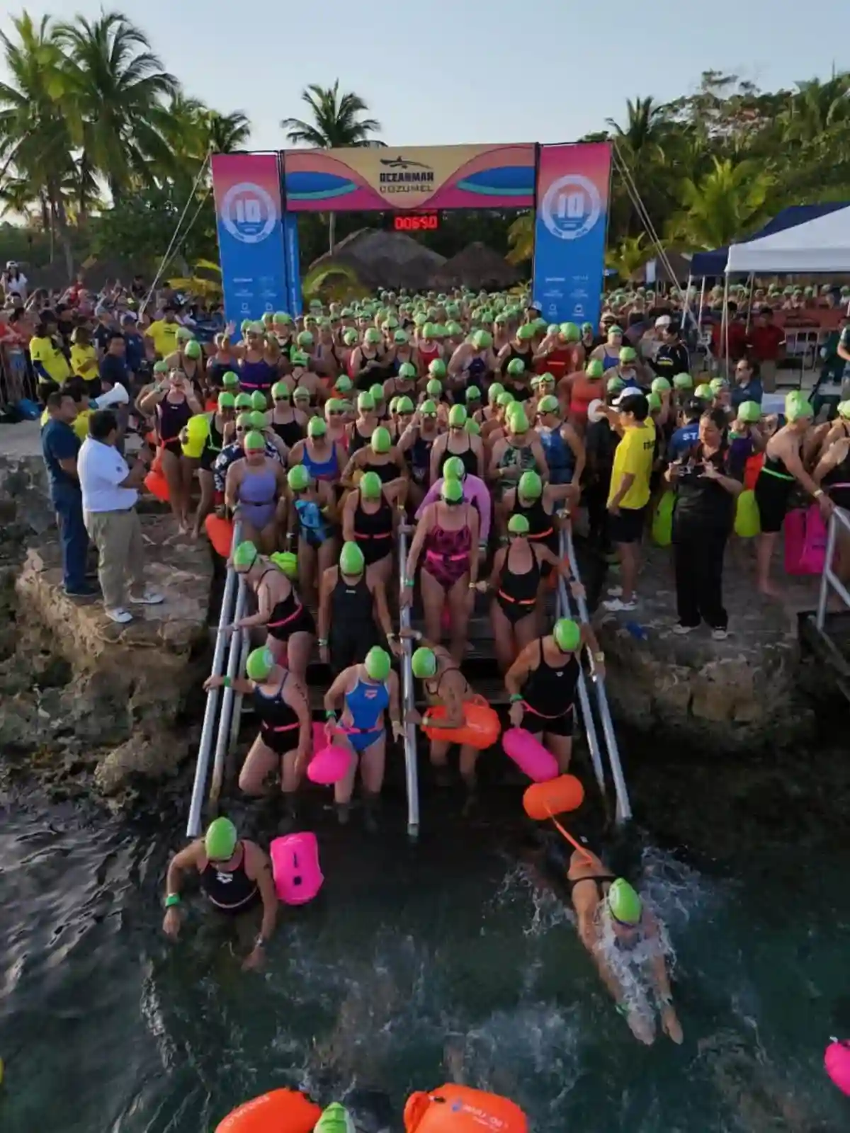Swimmers race in the Oceanman Cozumel 2026 open water competition at Chankanaab Natural Park.
