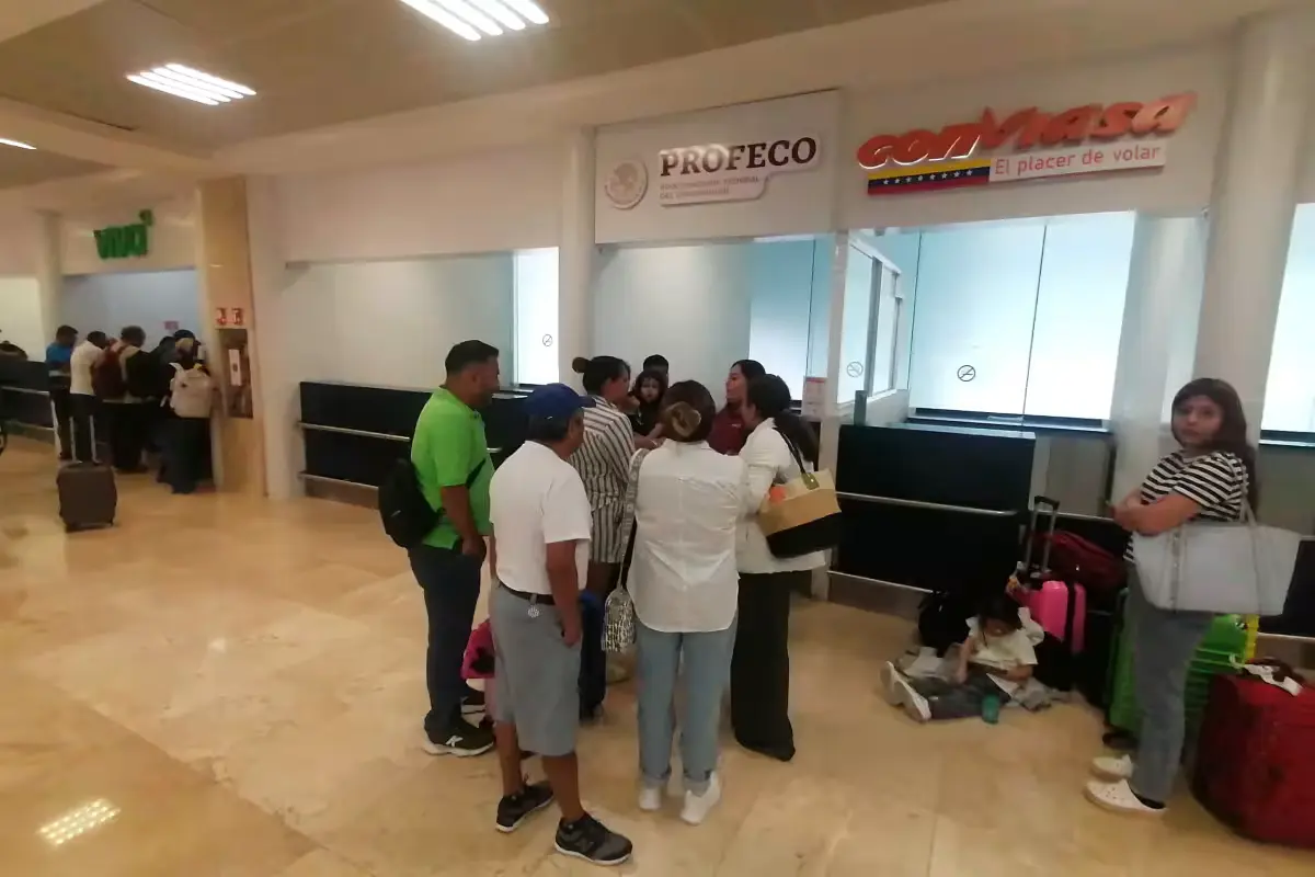 Passengers wait at Cancun International Airport after their flight was overbooked
