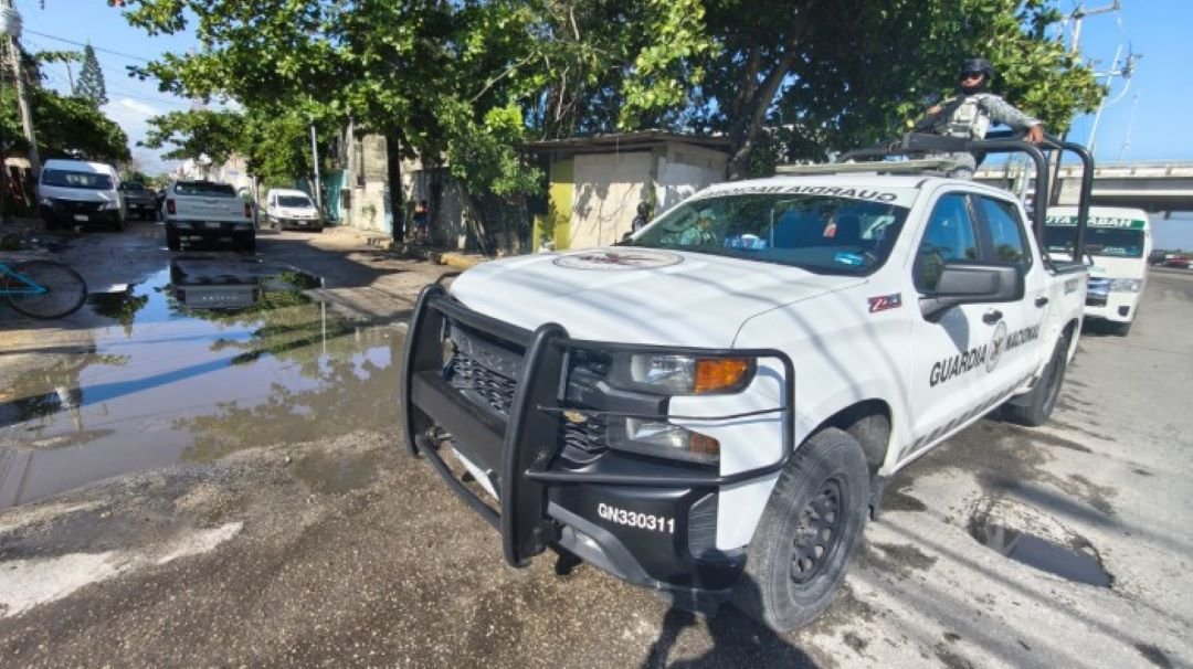Law enforcement officers at the scene of a raid in Playa del Carmen, Mexico