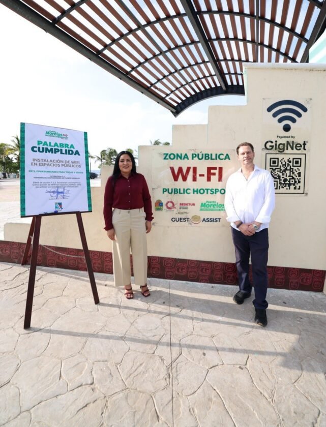 People use smartphones at Fundadores Park in Puerto Morelos, where the city activated free Wi-Fi