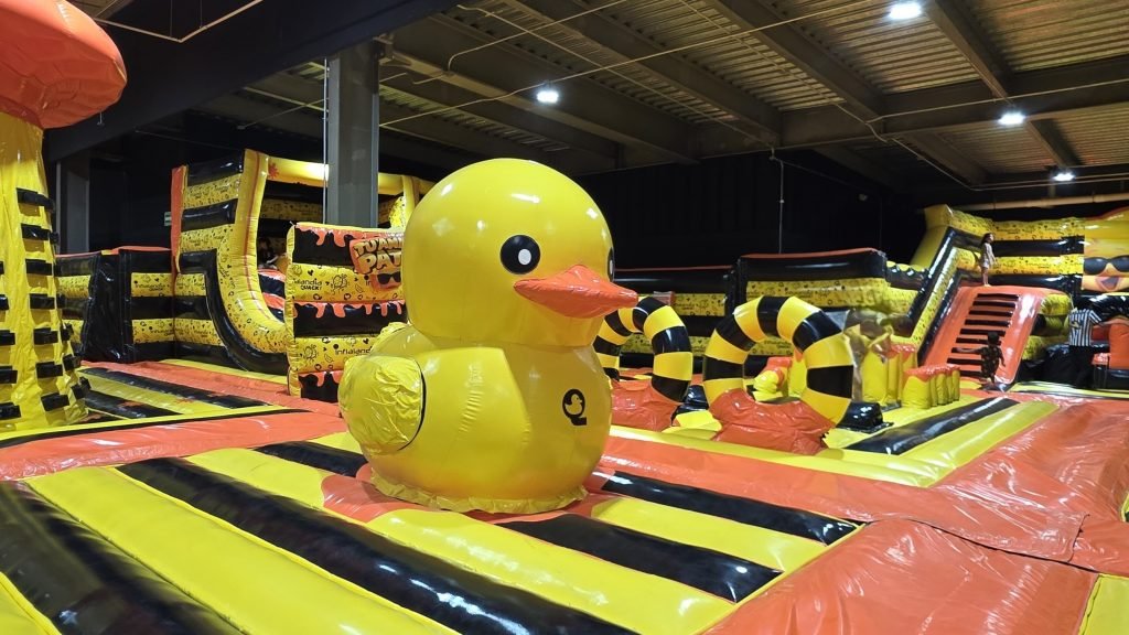 Families enjoy inflatable slides and obstacle courses at Quack park inside Go Grand Outlet Riviera Maya in Cancun
