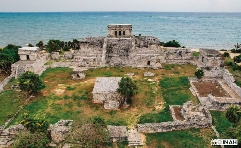 Visitors walking through an archaeological site in Quintana Roo, Mexico
