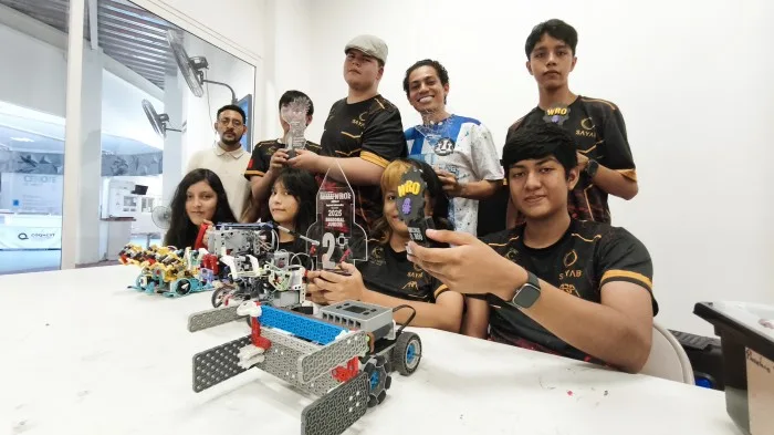 Students from the Astro-Engineers Robotics Club at the Sayab Planetarium in Playa del Carmen with the robots they built