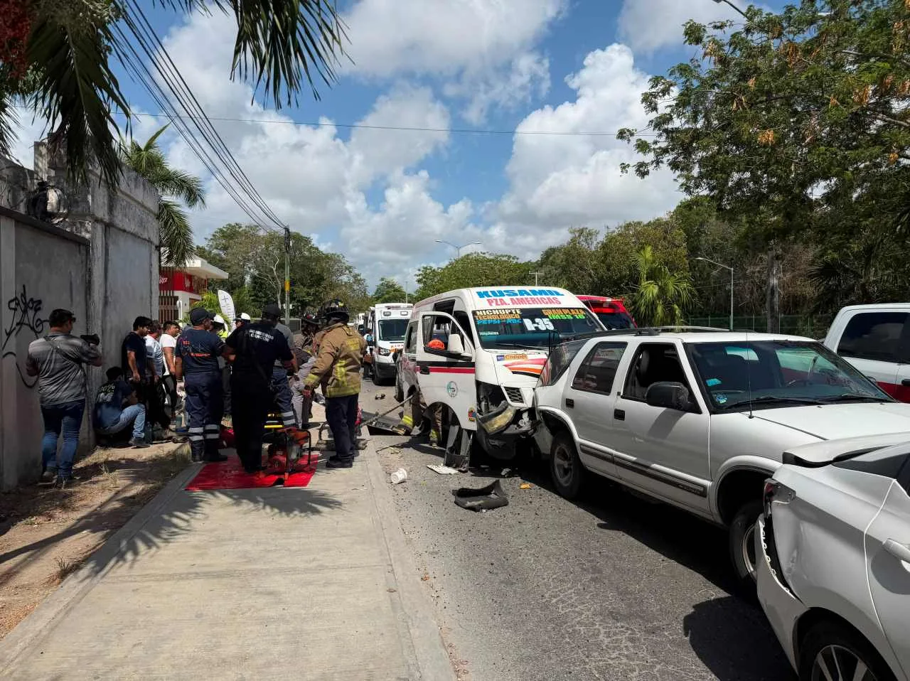 Emergency personnel assist injured people at the scene of a six-vehicle pileup on Avenida Nichupté in Cancún.