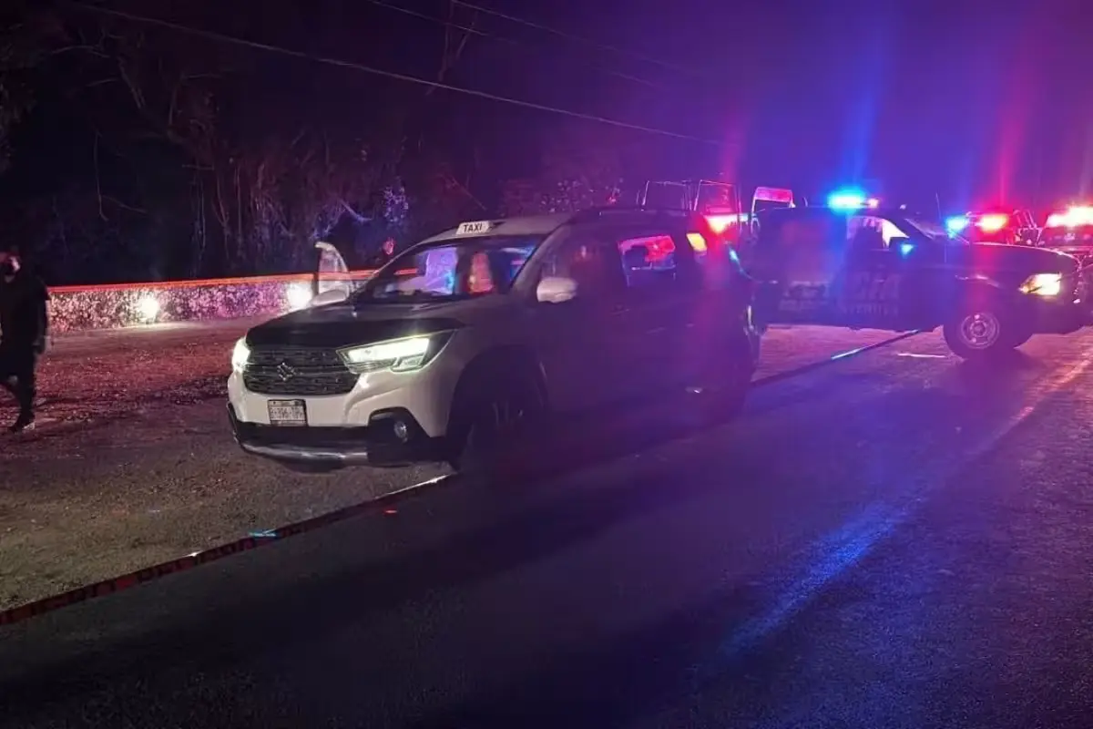 Authorities near a taxi cab on the Tulum-Cobá highway after a driver was found dead.