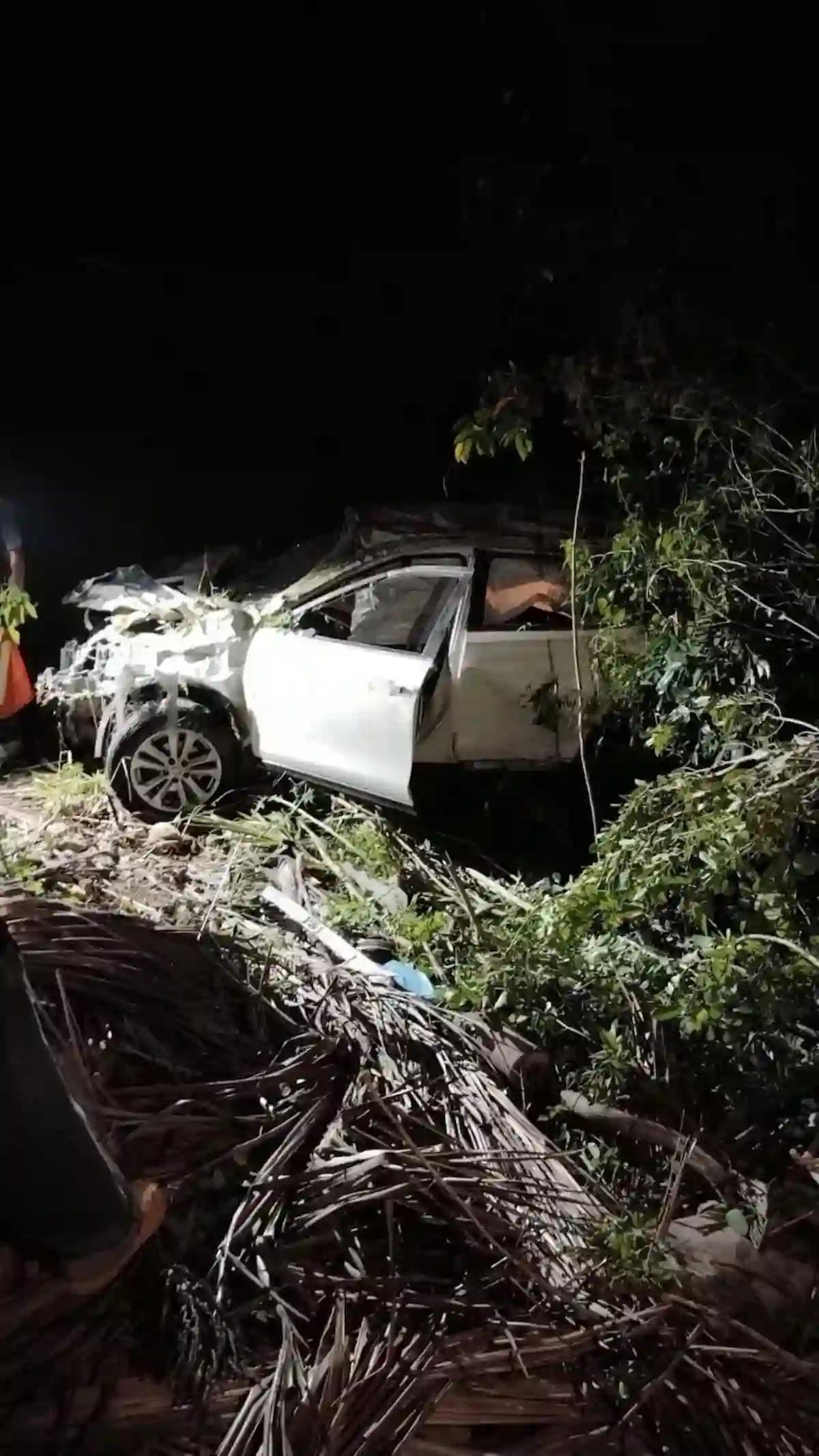 A vehicle lies overturned on Federal Highway 307 after a head-on collision near Noh-Bec, Quintana Roo.