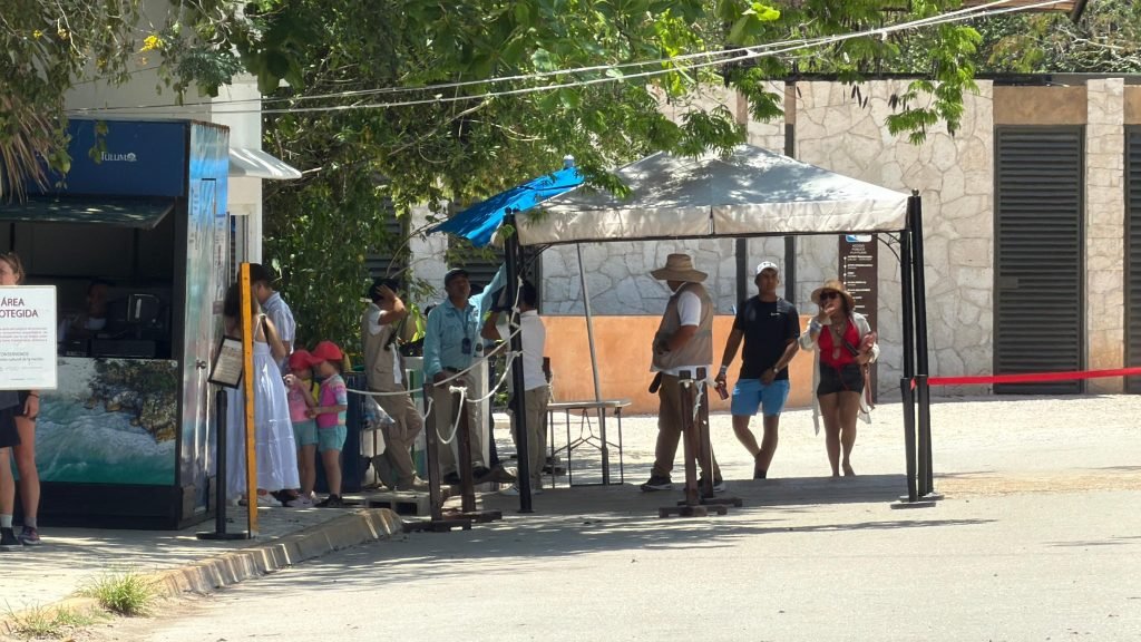 Tourism touts standing near traffic on Federal Highway 307 at the entrance to the Tulum archaeological zone