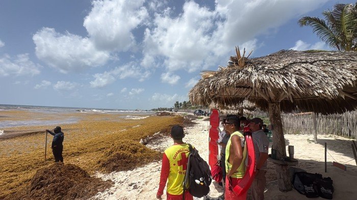 Paramedics attend to a fisherman who suffered decompression sickness at a beach in Tulum.