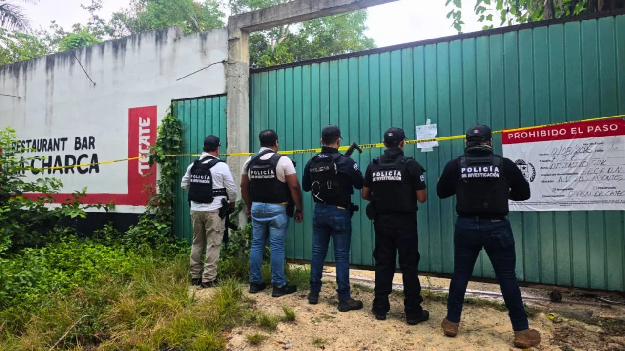 Law enforcement officers outside a property sealed during a drug raid in Quintana Roo, Mexico.
