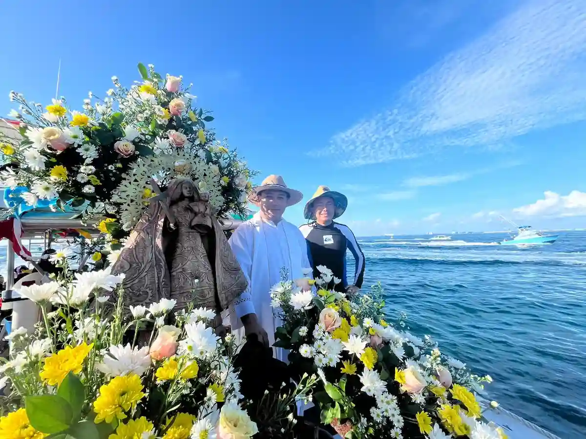 A line of fishing and tourism boats sails from Isla Mujeres toward Isla Contoy during the annual maritime procession in honor of the Virgen de la Caridad del Cobre